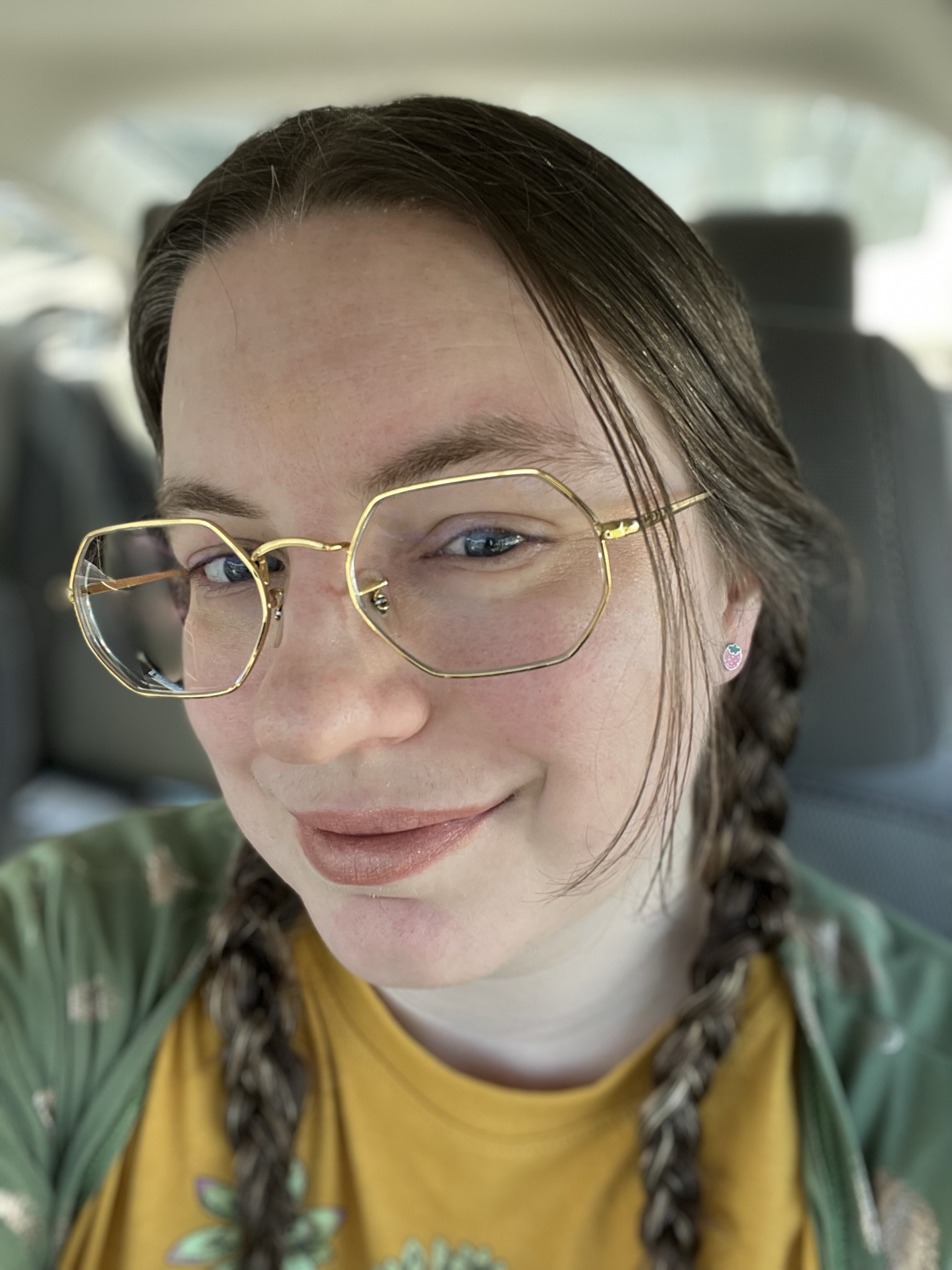 Me with my hair braided and ears pierced with small pink strawberry earring